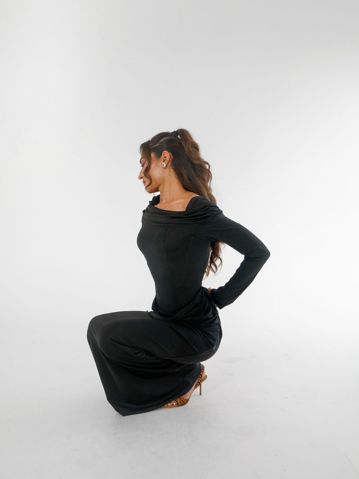 Paradox black dress seated editorial view