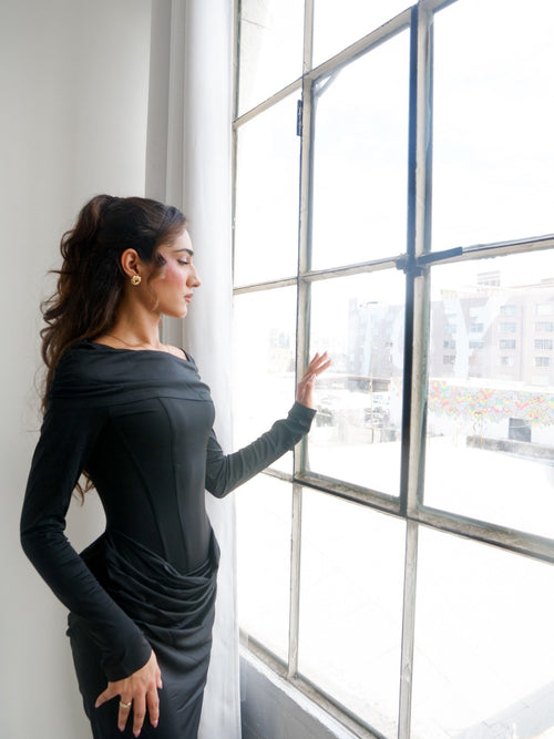 Paradox black dress by the window